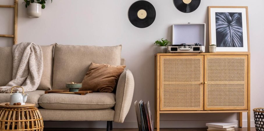 stylish-composition-living-room-interior-with-beige-sofa-pillow-plaid-coffee-table-rattan-commode-personal-accessories-beige-wall-mock-up-poster-template